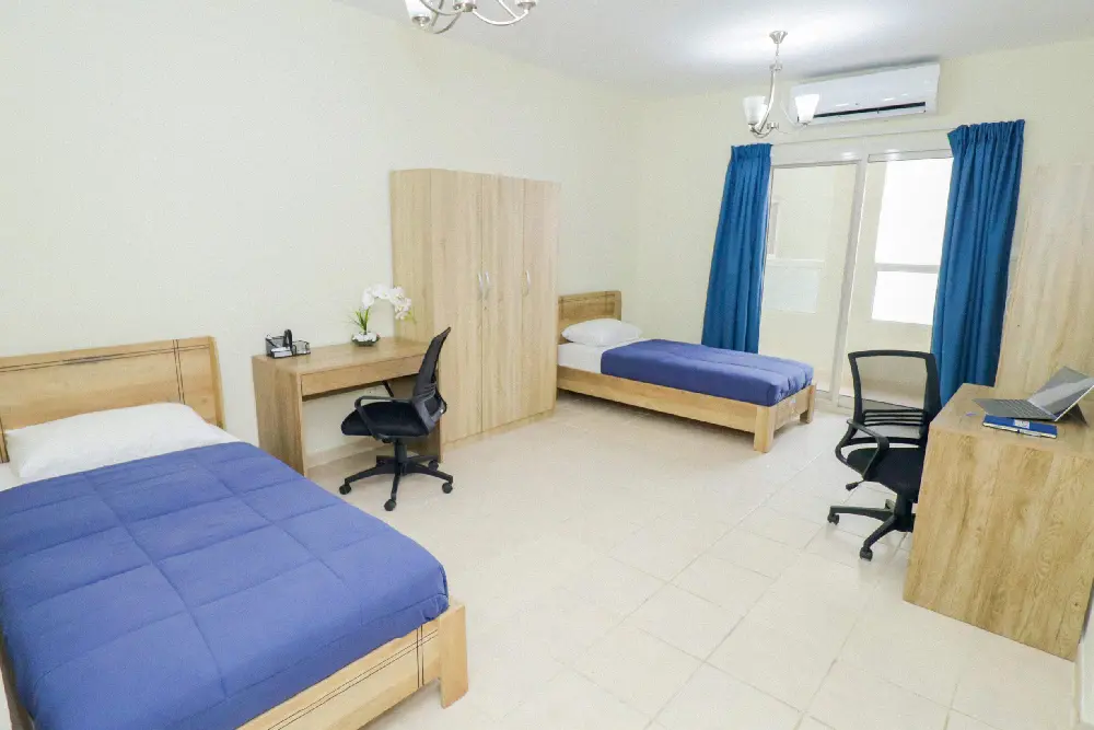 Student residence Dubai shared accommodation room with study desks, beds, and modern facilities